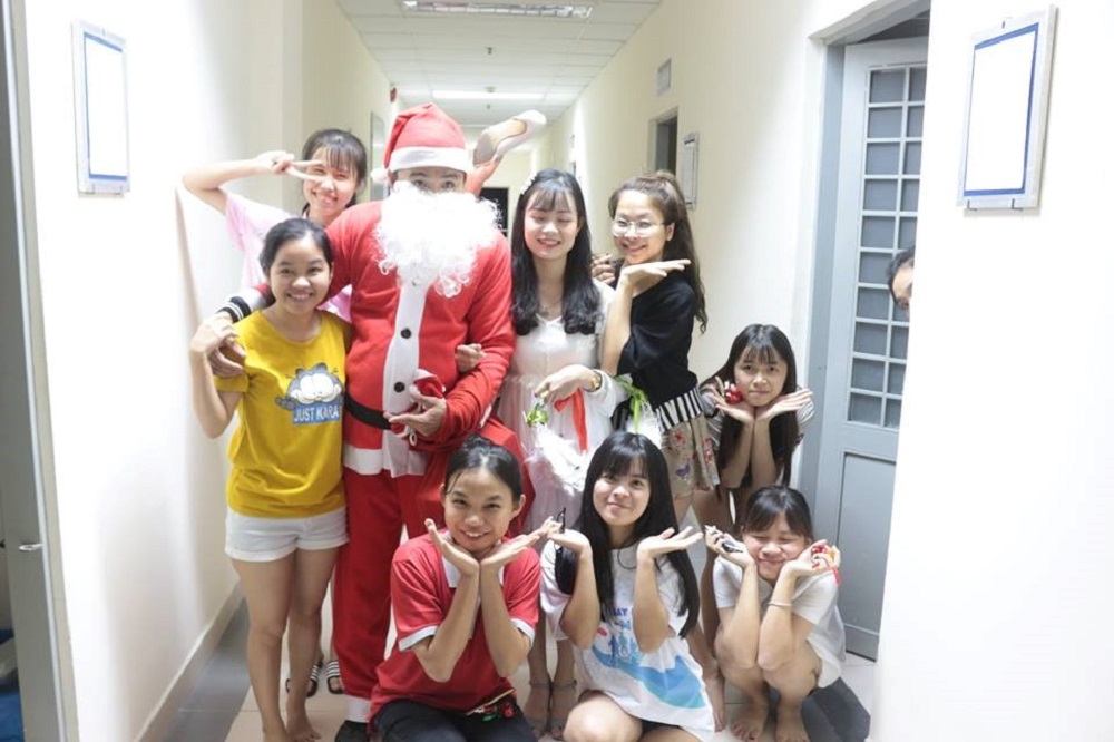 Santa Claus and Snow princess taking picture with students