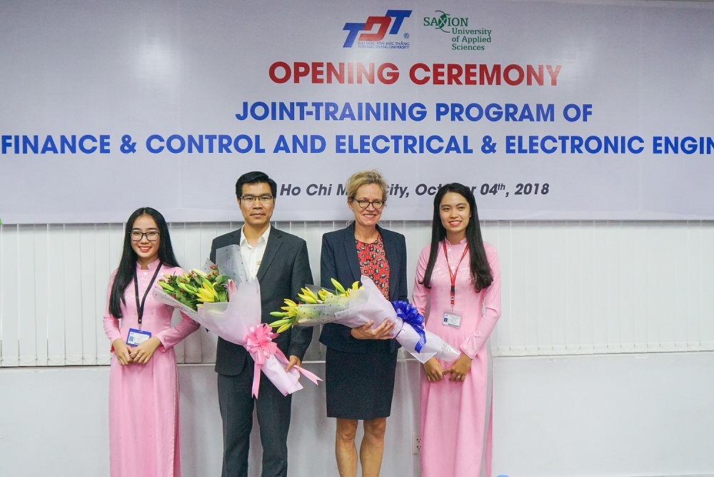 Representatives of freshmen presenting flowers to leaders of two universities-2